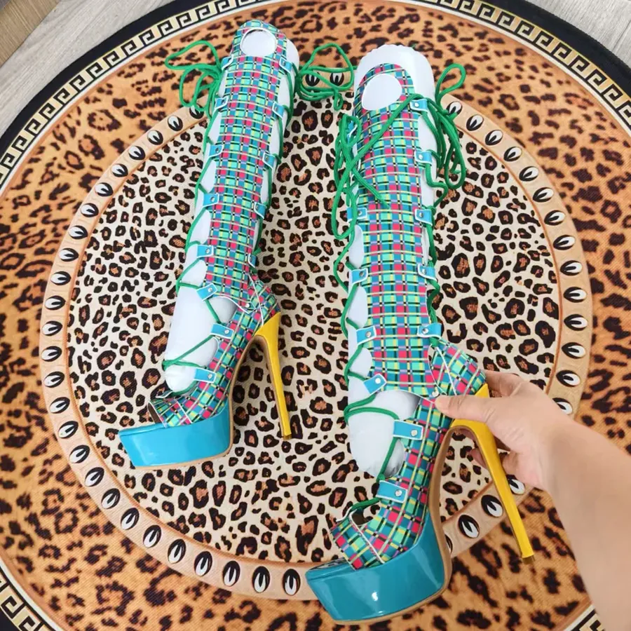 A pair of turquoise platform heels with green laces, on a leopard print rug